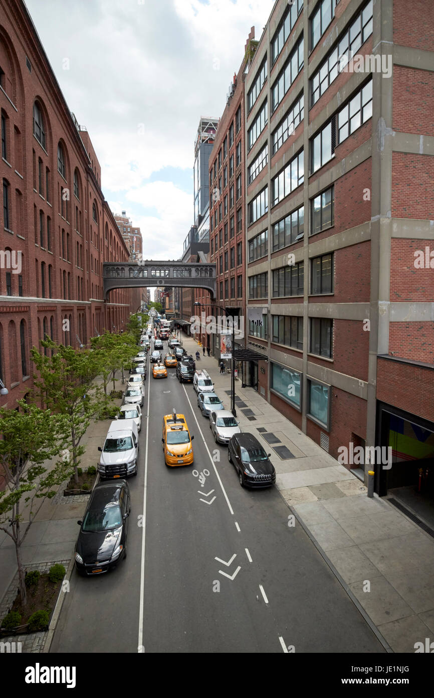 looking down west 15th street between chelsea market on the left and milk studios building New York City USA Stock Photo