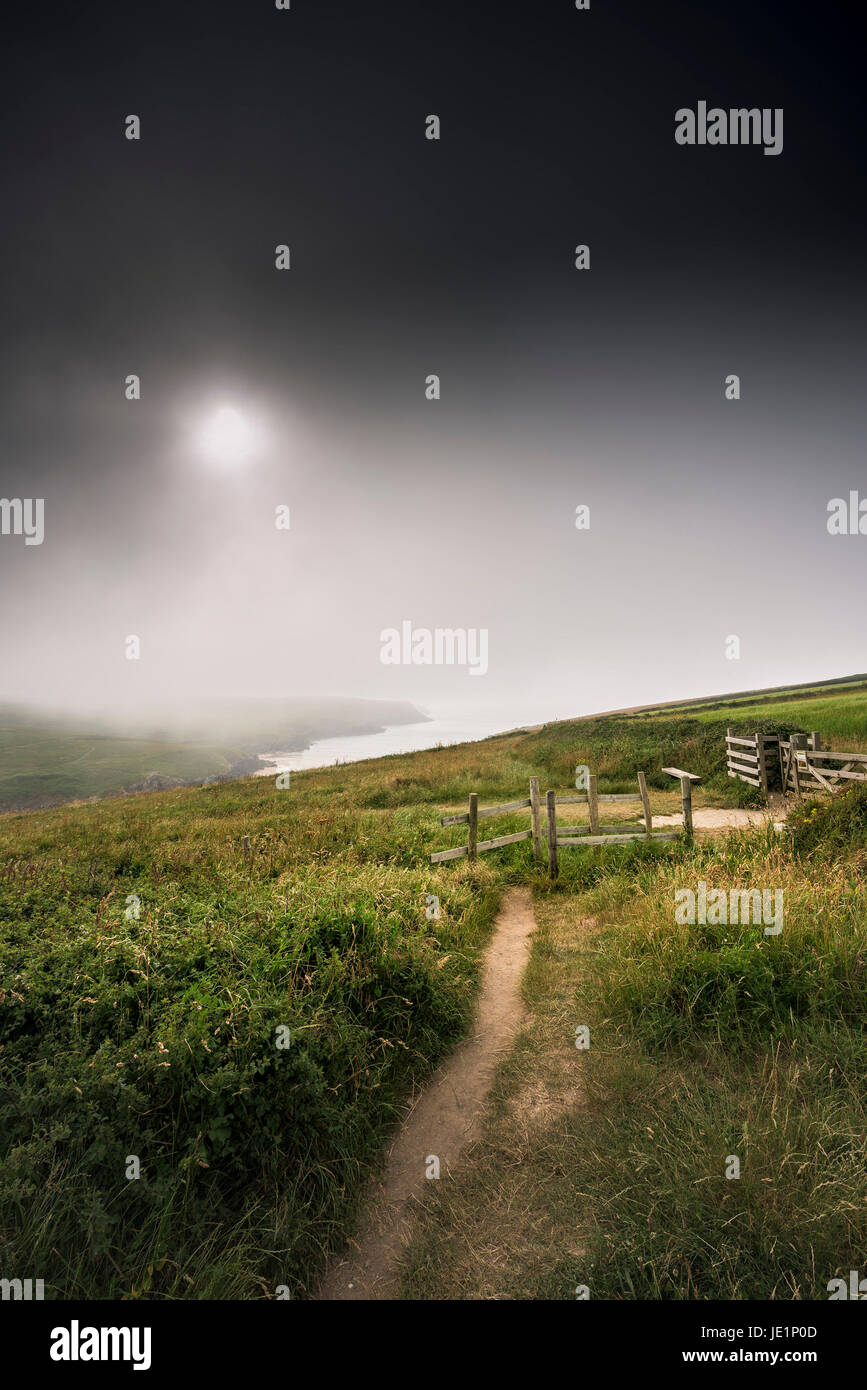 Sea mist and heavy rainclouds approaching West Pentire in Newquay, Cornwall. Stock Photo