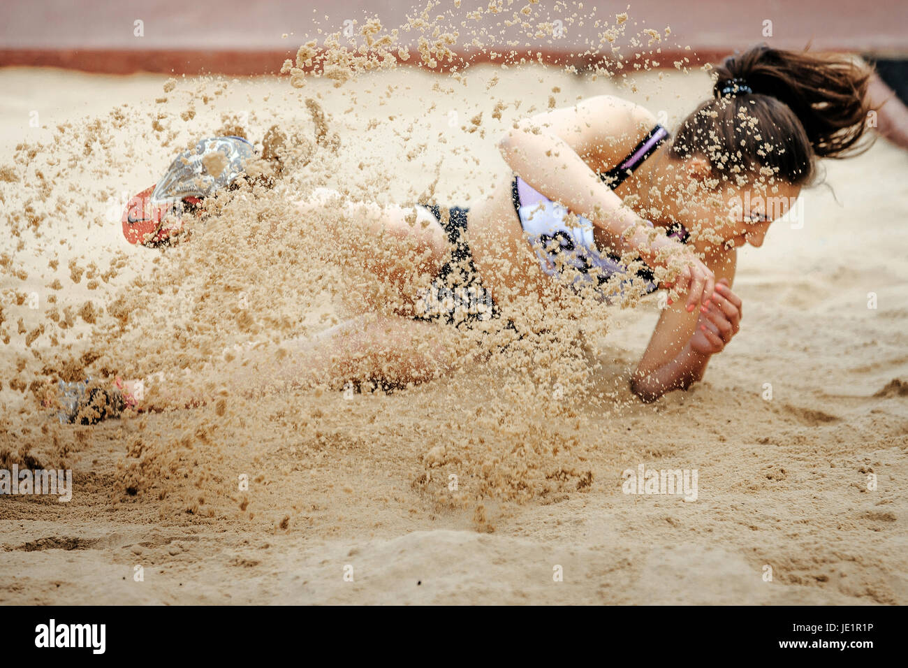 women jumper landing in sand long jump during UrFO Championship in athletics Stock Photo
