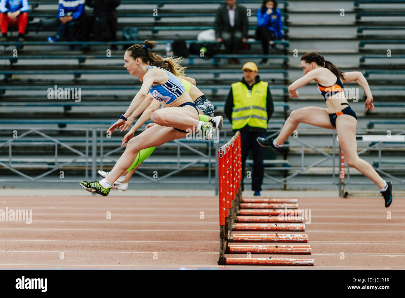 women running race in 100 meter hurdles during UrFO Championship in athletics Stock Photo