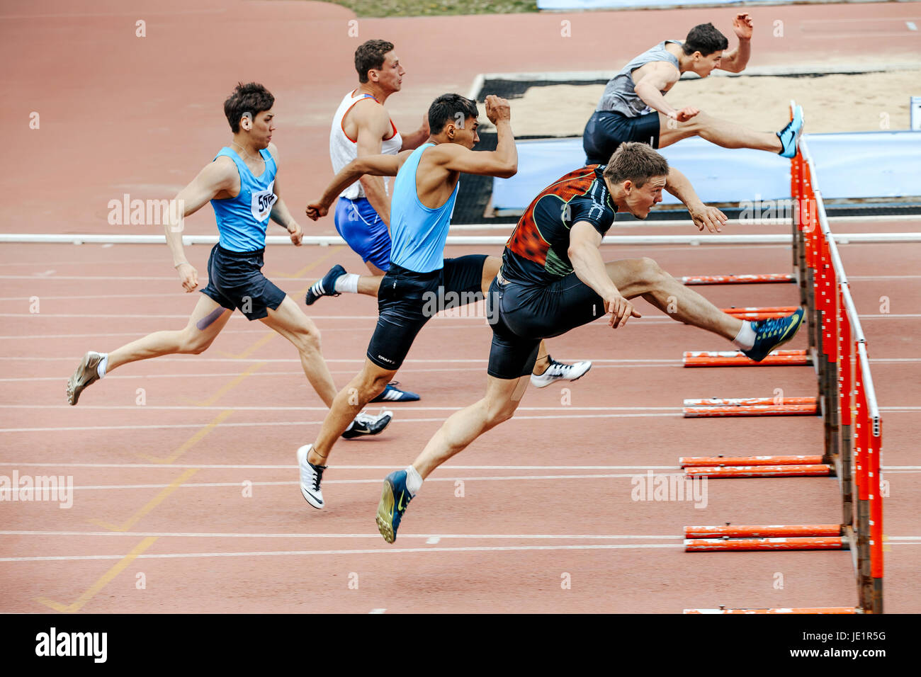 men runners running race in 110 meter hurdles during UrFO Championship in athletics Stock Photo