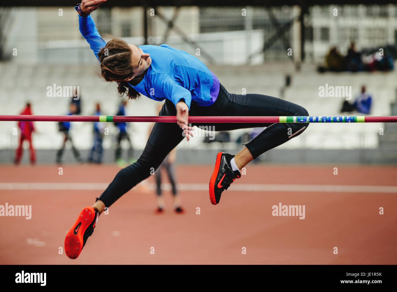 female athlete jumping successful attempt at high jump during UrFO Championship in athletics Stock Photo