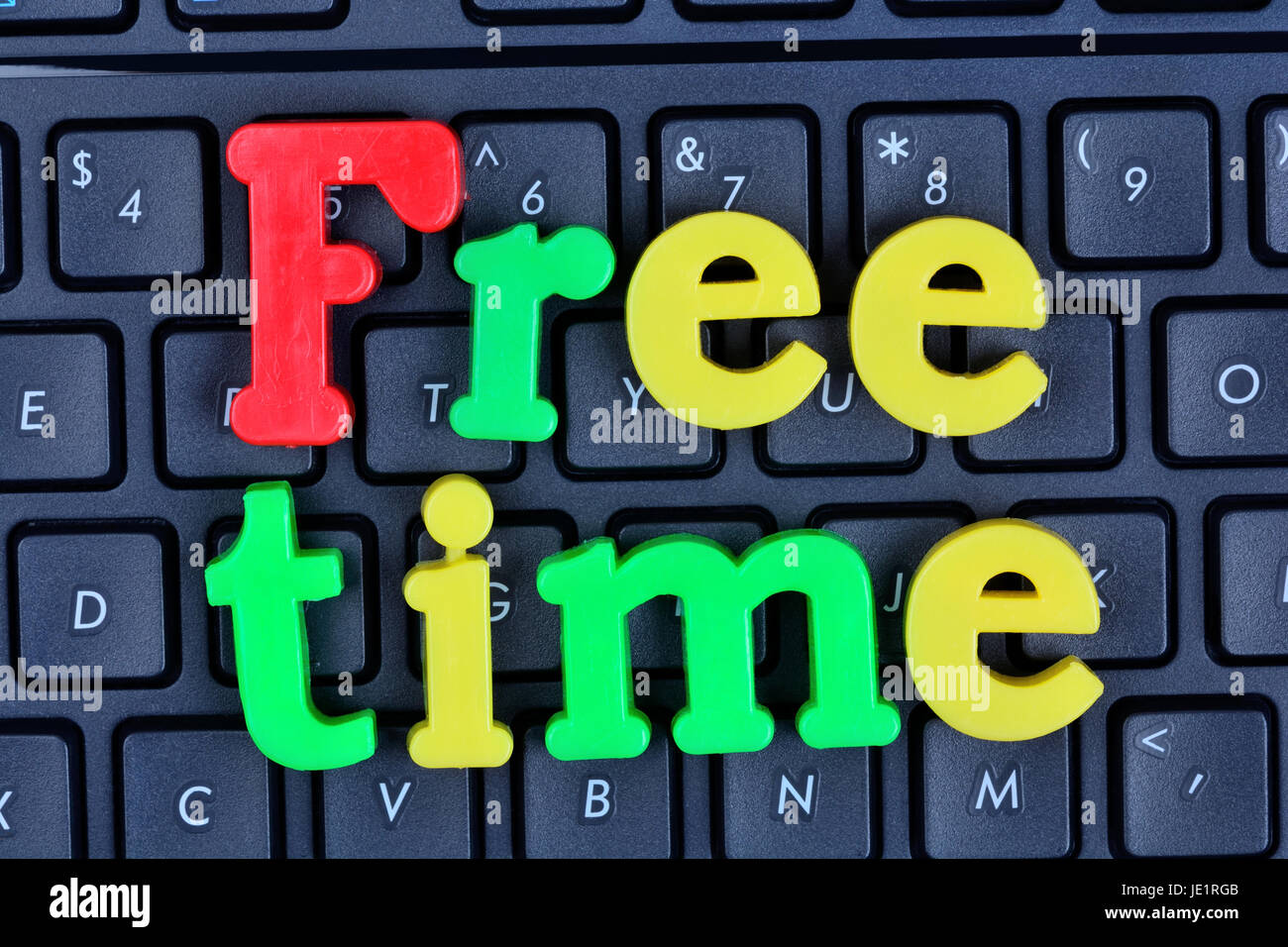 Free time words on computer keyboard closeup Stock Photo - Alamy