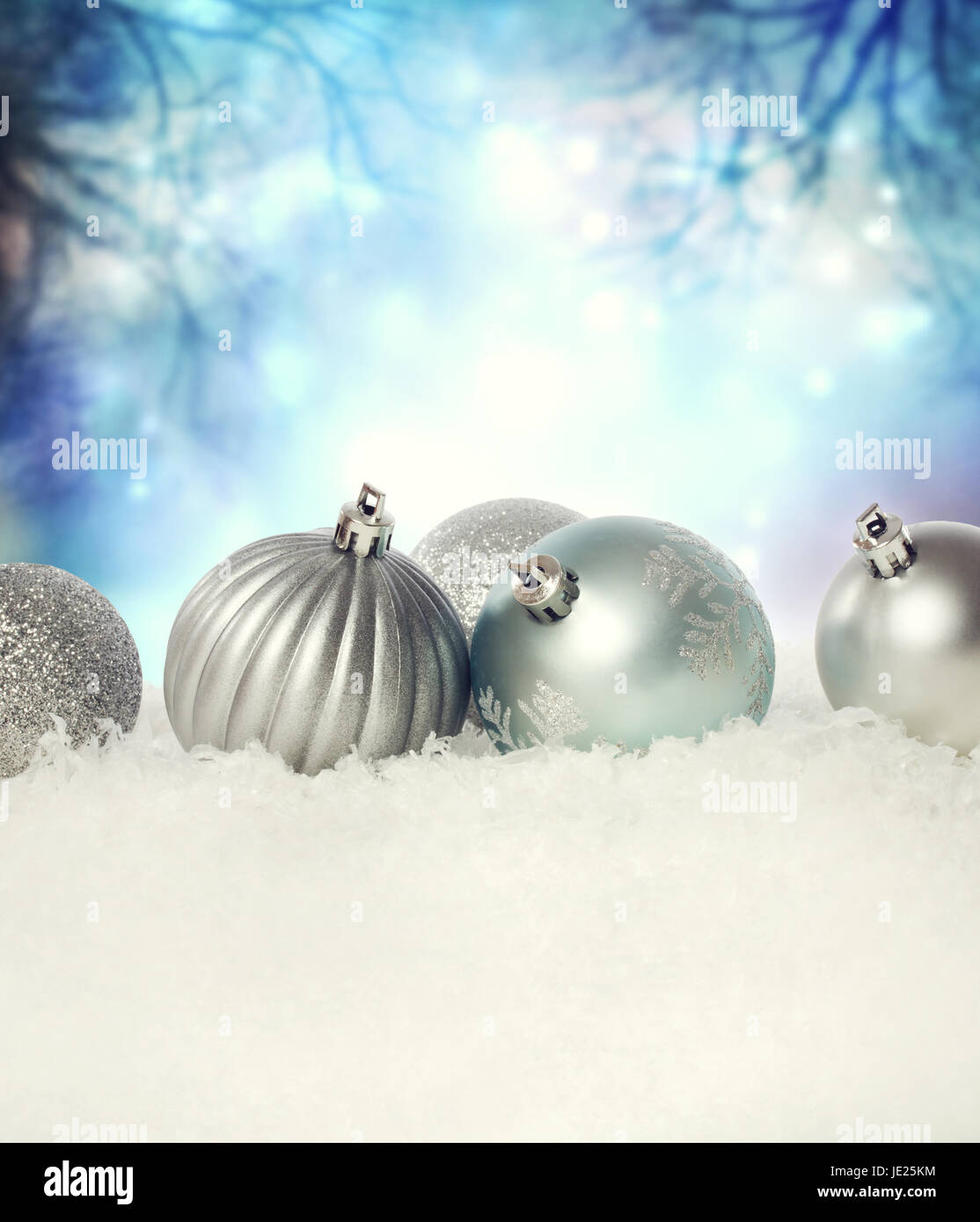 Silver Christmas baubles on the snow in the night Stock Photo - Alamy