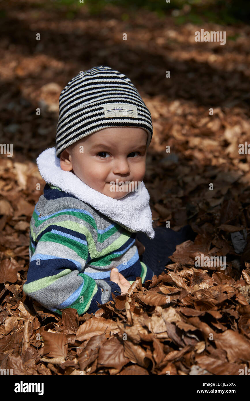 Forest child fall foliage sitting hi-res stock photography and images ...