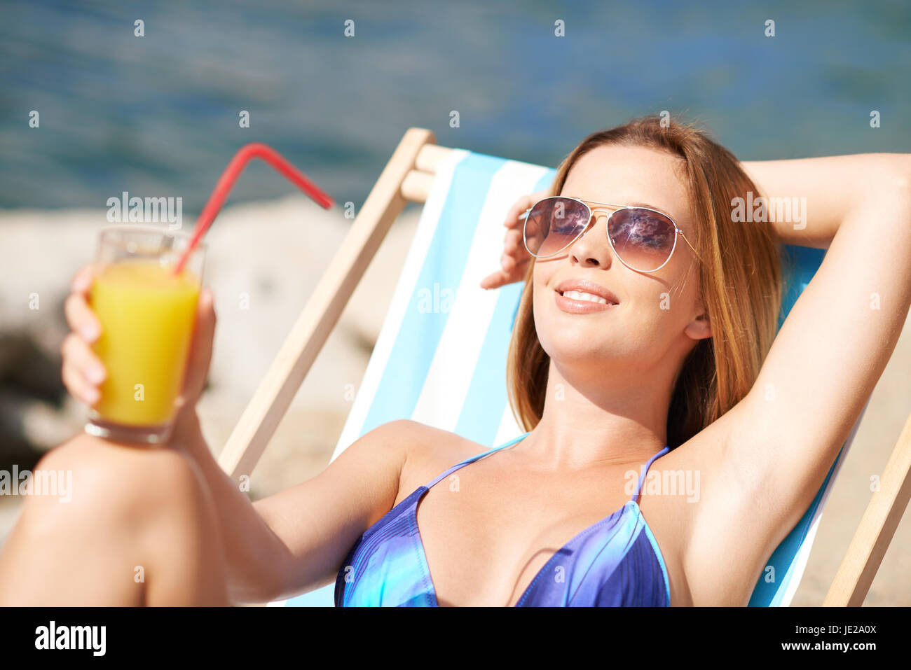 Portrait of a woman relaxing in deck-chair Stock Photo