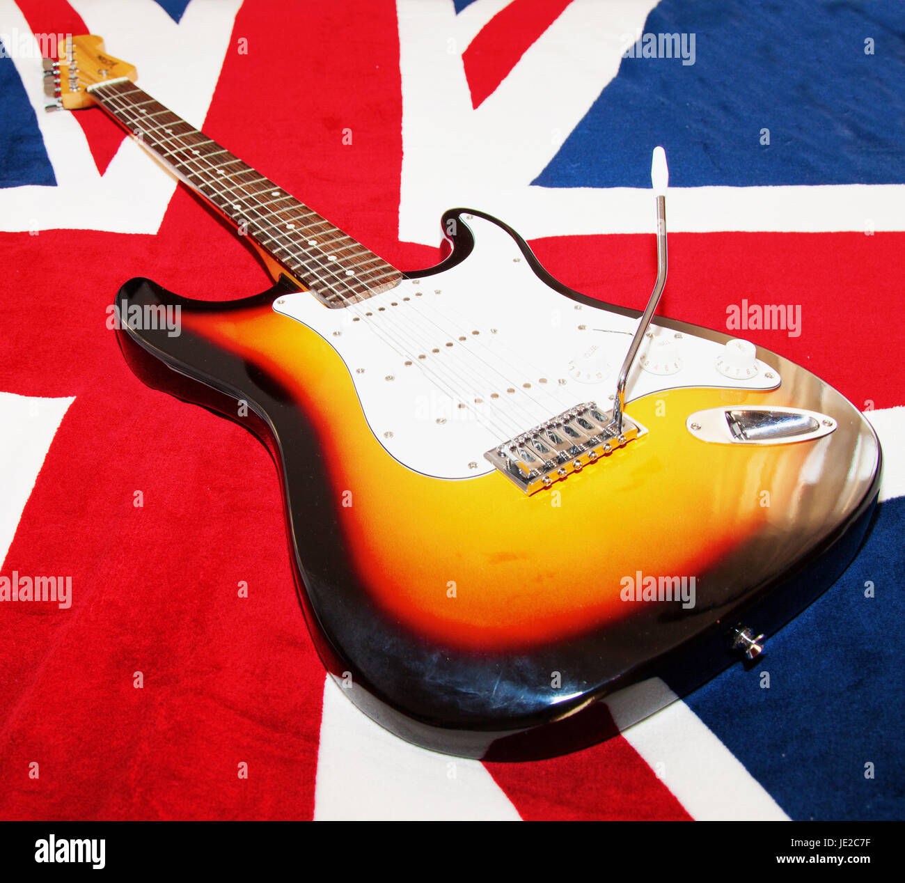 CASALE MONFERRATO, OCTOBER 5, 2014: Vision electric guitar (replica of  Fender Stratocaster) over a UK flag. Fender Stratocaster is one of most  famous and replied guitars in the world, and classic for