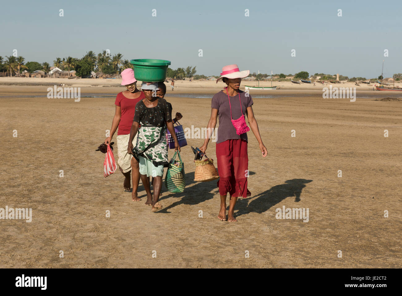 Women carrying fish to market, Morondava, Madagascar Stock Photo