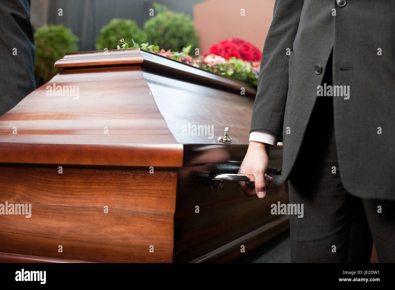 Religion death and dolor coffin bearer carrying casket at funeral to
