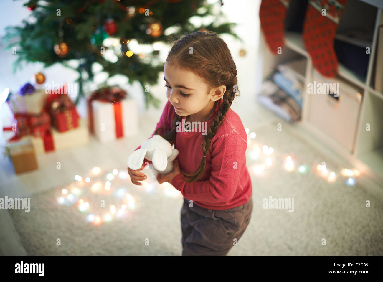 Cute girl with toy playing at home Stock Photo - Alamy