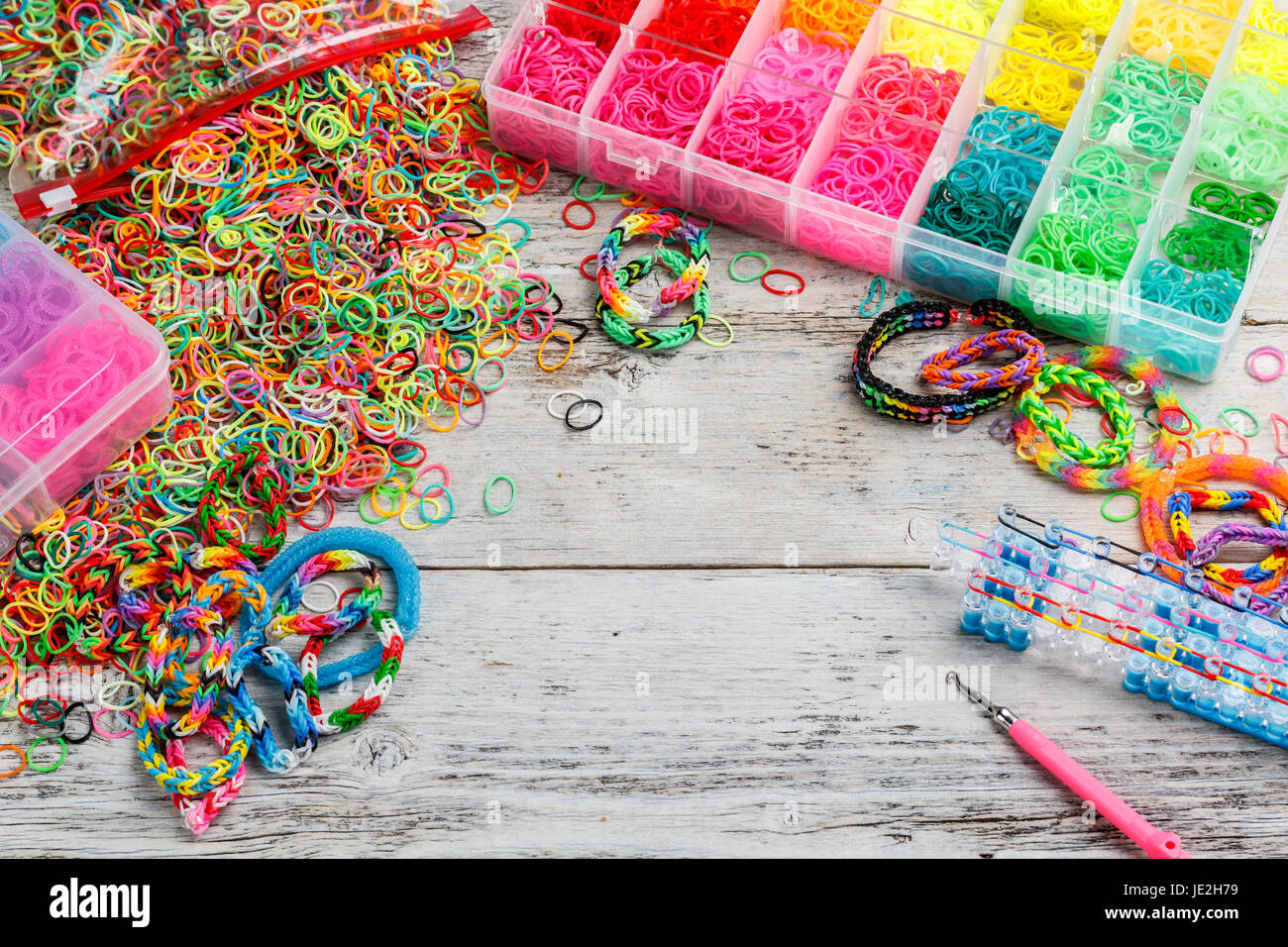 Colorful elastic loom bands with band loom, bracelets, tools and Stock  Photo - Alamy