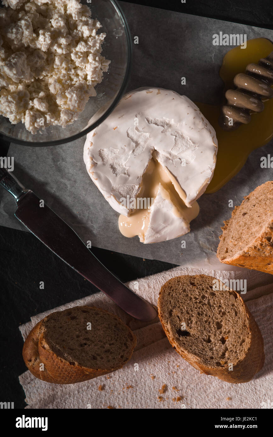 Brie cheese with honey and bread on the background vertical Stock Photo