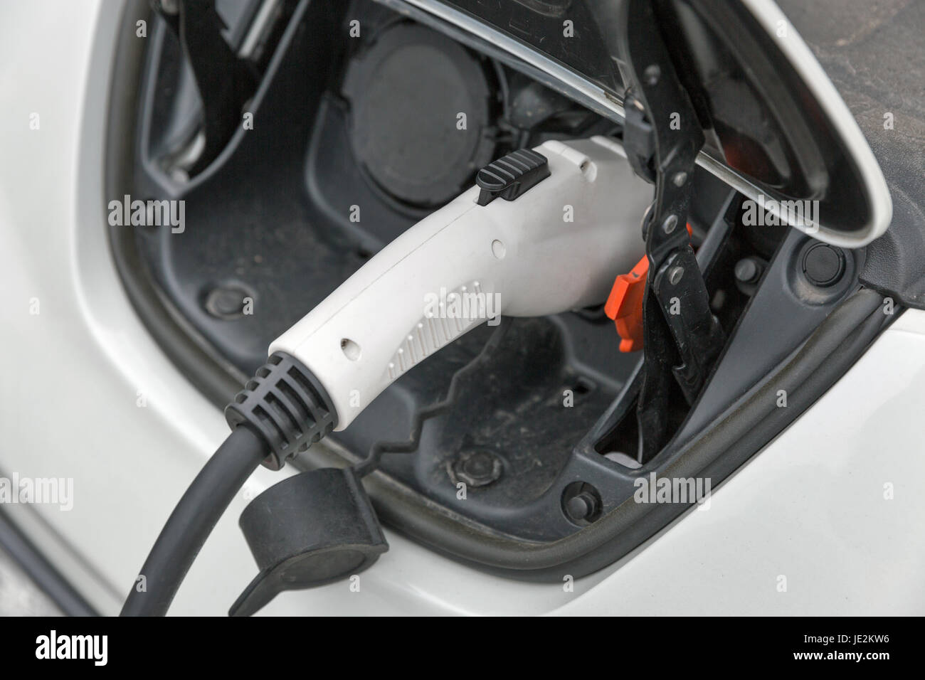 Charging an white electric car closeup Stock Photo