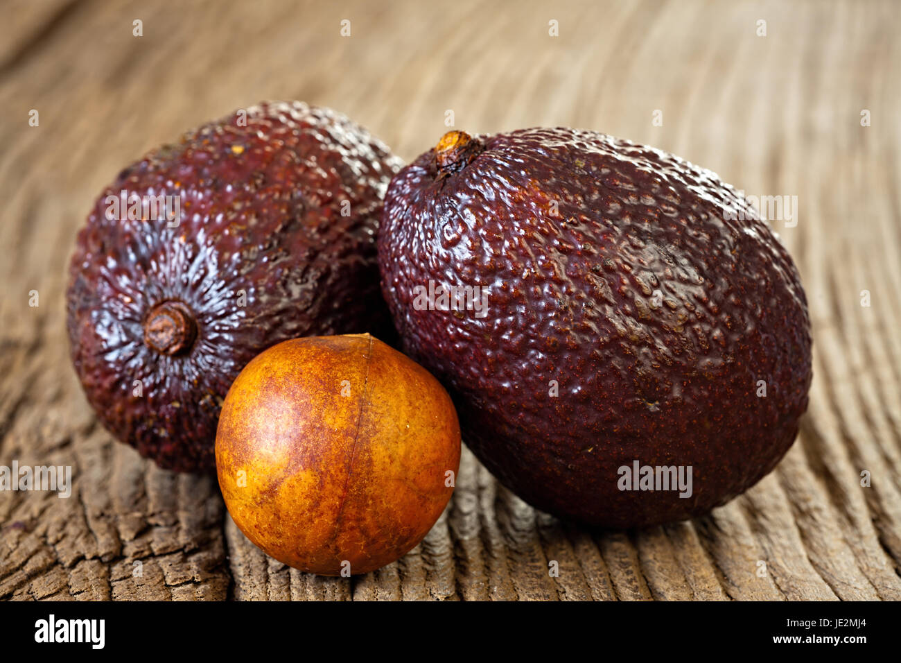 Avocado Stub Ripe Close up view of two ripe avocados and avocado stone on an old rustic ...
