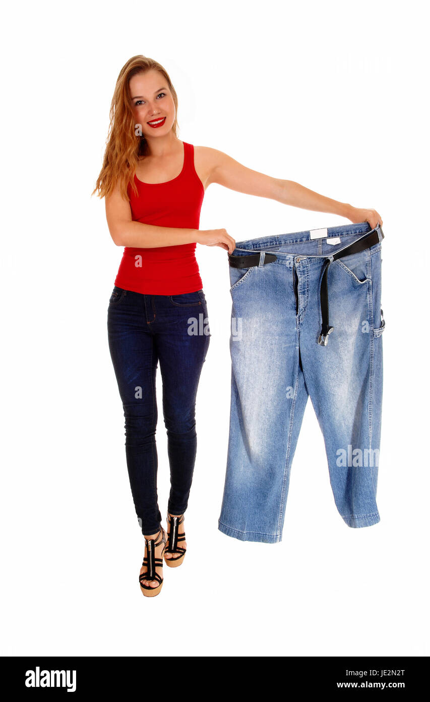 Young Slim Woman Showing How Much Weight She Lost. Stock Photo