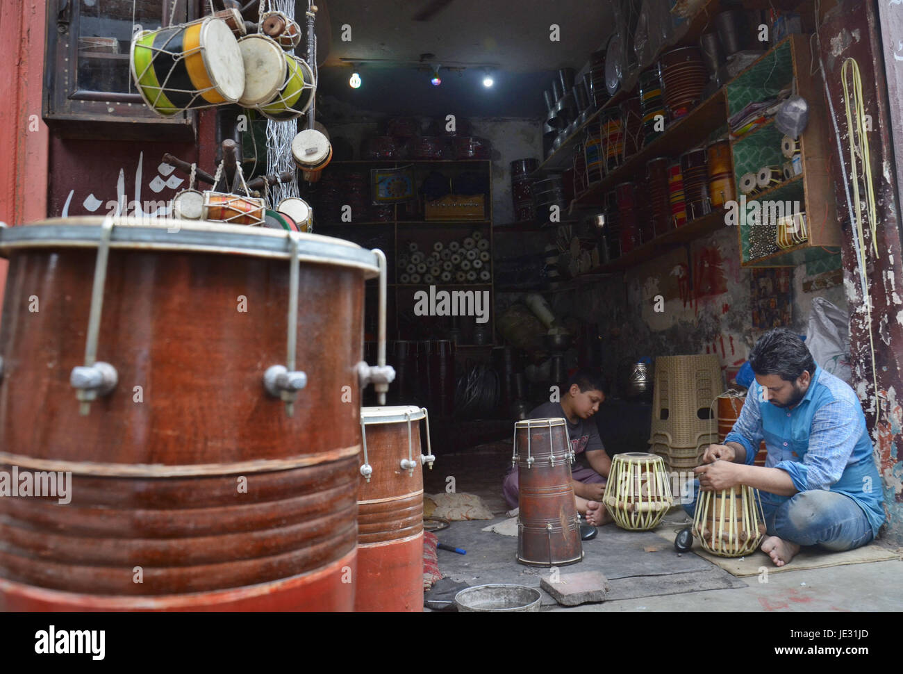 Lahore, Pakistan. 22nd June, 2017. Pakistani shopkeeper arranging their
