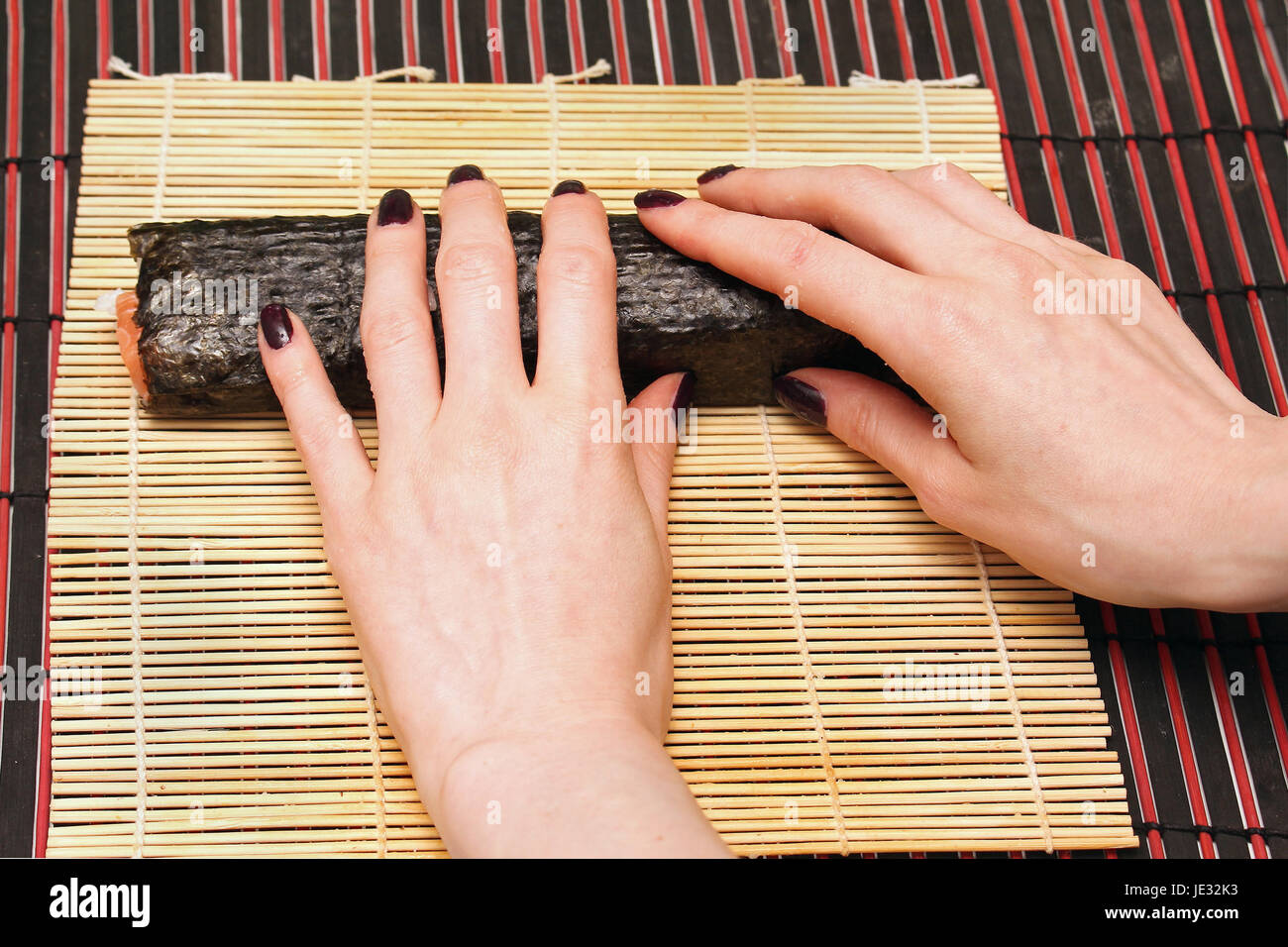 Female Hands Rolling Sushi On Bamboo Mat Stock Photo 146356087