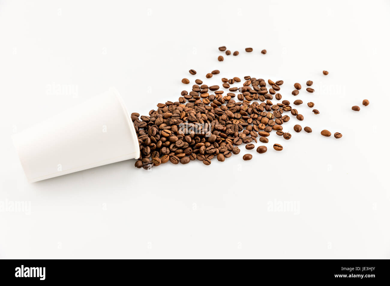 roasted coffee beans scattered of paper cup isolated on white Stock ...