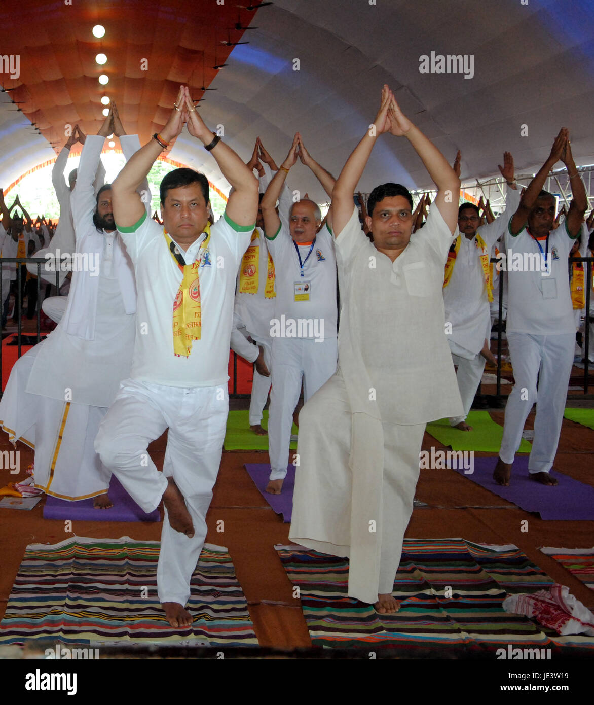 Assam Chief Minister Sarbananda Sonowal and Acharya Balkrishna (R), Managing Director of Patanjali Ayurved participate in yoga session on the occasion of the International Day of Yoga, at Gurdon High School Playground in Nalbari District of Assam on Wednesday, June 21, 2017. Millions of yoga enthusiasts across India take part in a mass yoga sessions to mark the third International Yoga Day which falls on June 21 every year. People participate in a mass yoga session on the occasion of the International Day of Yoga, at Gurdon High School Playground in Nalbari District of Assam on Wednesday, Ju Stock Photo