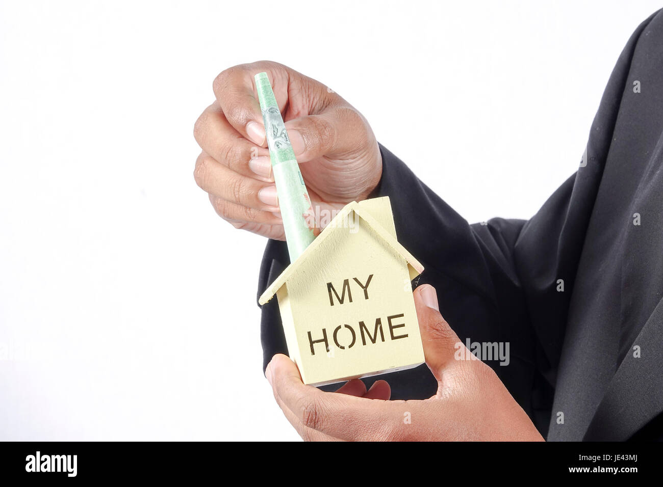 young businessman holding a house model Stock Photo - Alamy