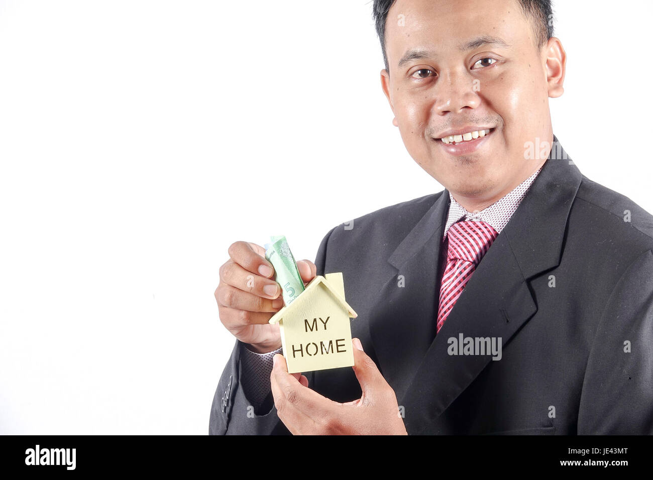 young businessman holding a house model Stock Photo - Alamy