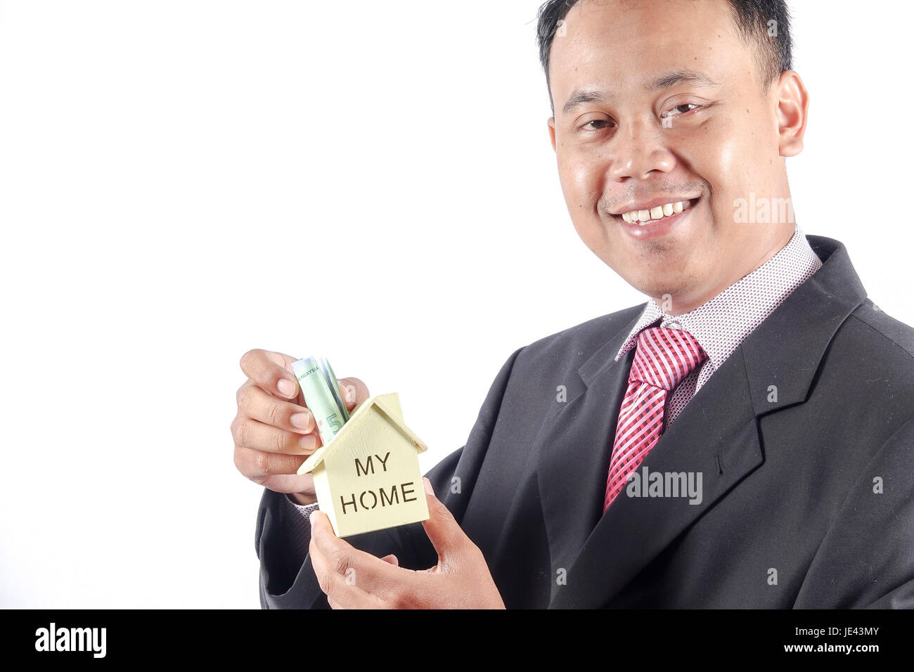 young businessman holding a house model Stock Photo - Alamy