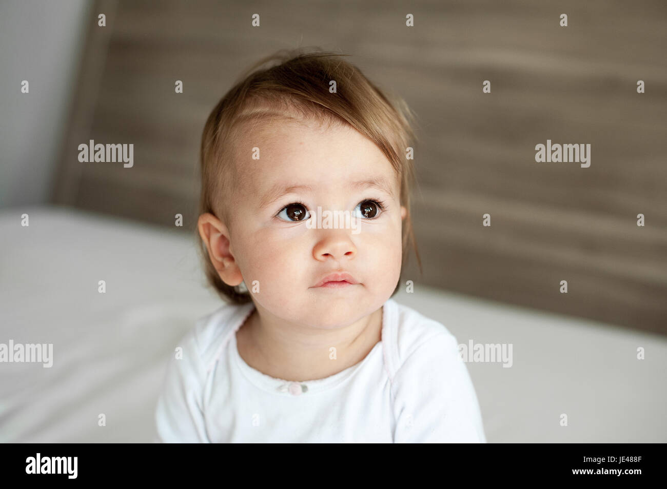 Friendly one year old baby feeling reflective Stock Photo