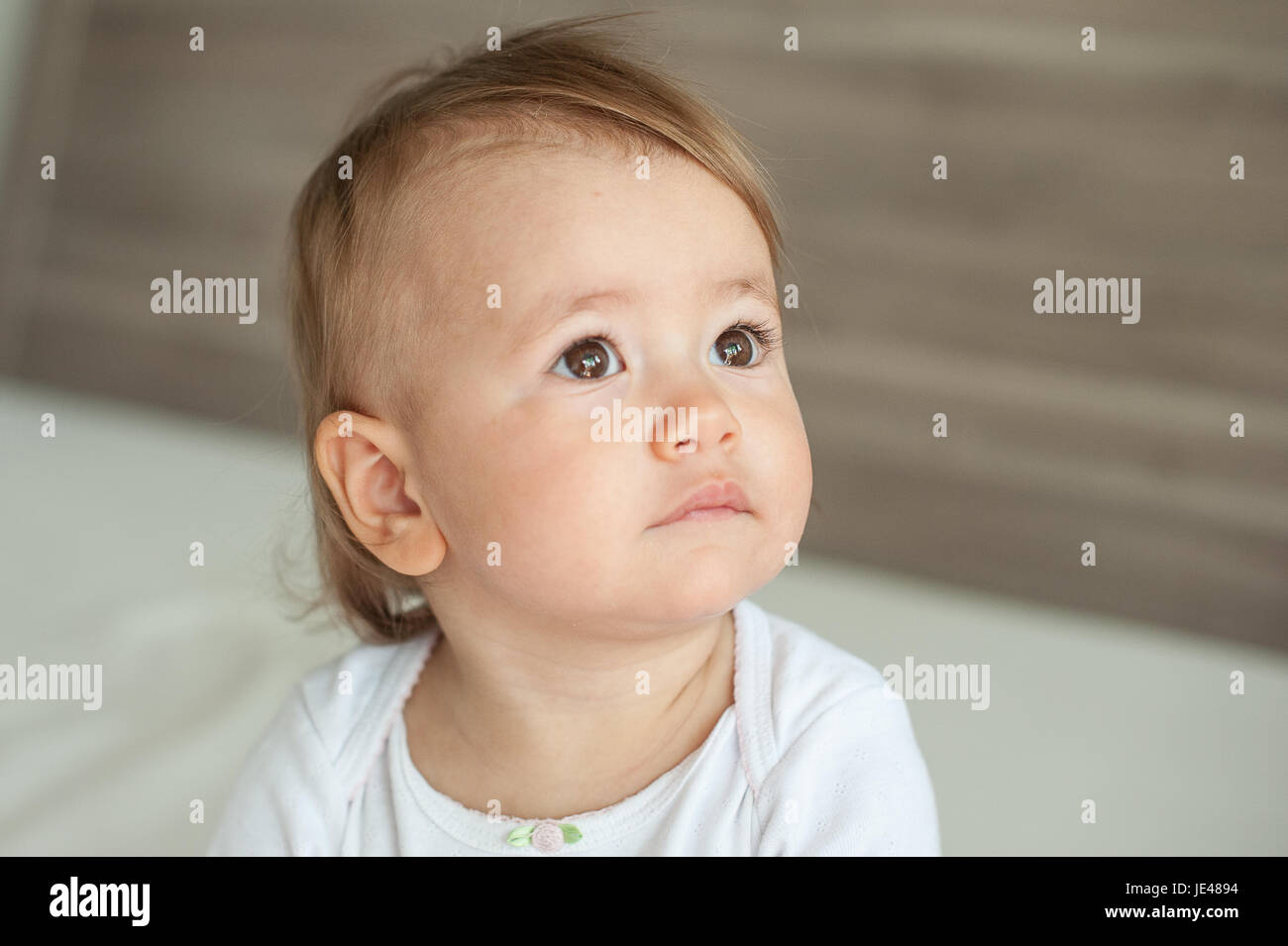 Friendly one year old baby feeling reflective Stock Photo
