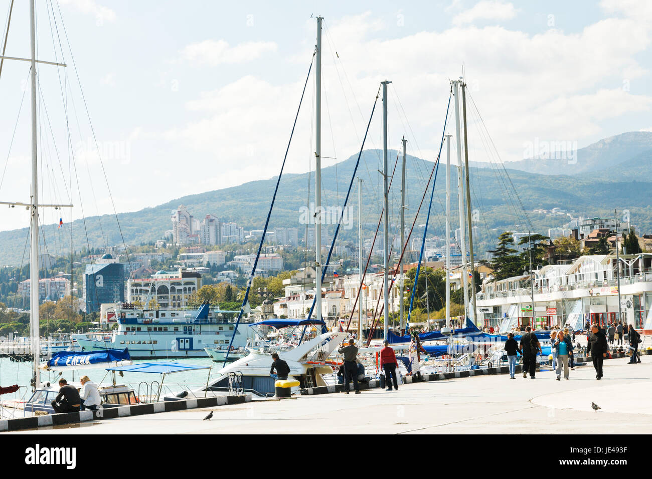YALTA, RUSSIA - SEPTEMBER 28, 2014: people on waterfront in Yalta city in September . Yalta is resort city on the north coast of the Black Sea on the Crimean peninsula. Stock Photo
