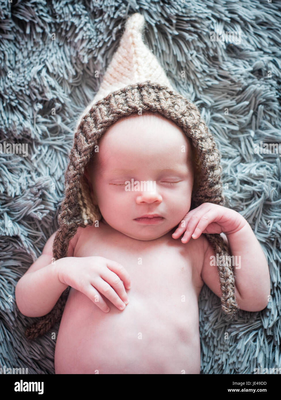 Newborn baby sleeps in a knitted hat Stock Photo