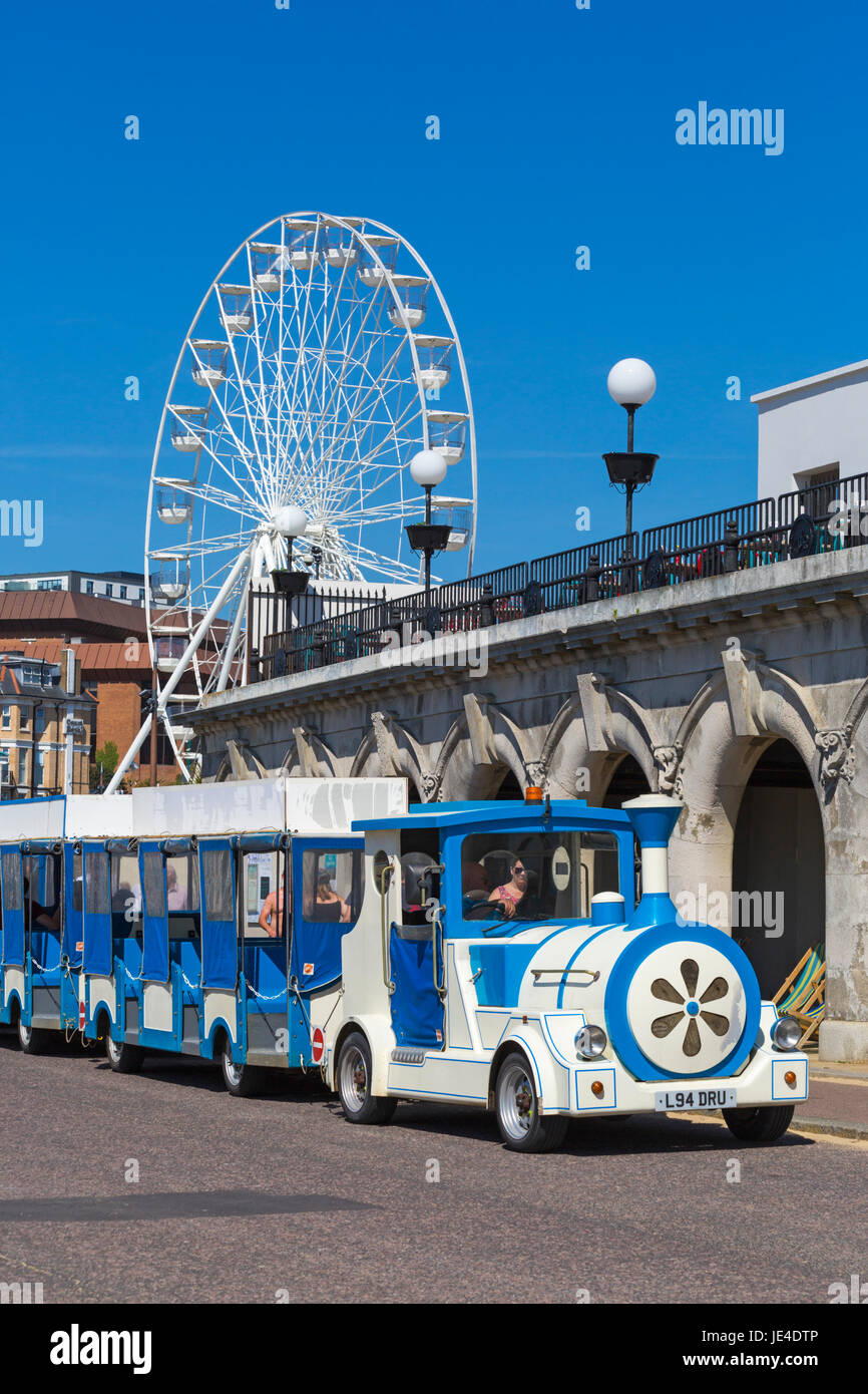 Landtrain on Bournemouth promenade with big wheel behind at Pier Approach, Bournemouth, Dorset in June Stock Photo