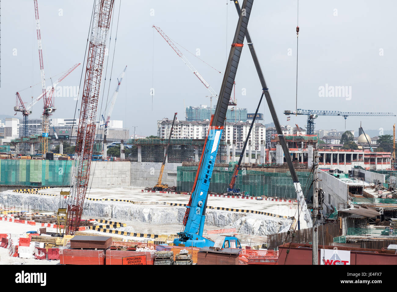 Cranes operate at the under construction Tun Razak Exchange financial district, developed by TRX City Sdn., in Kuala Lumpur, Malaysia Stock Photo