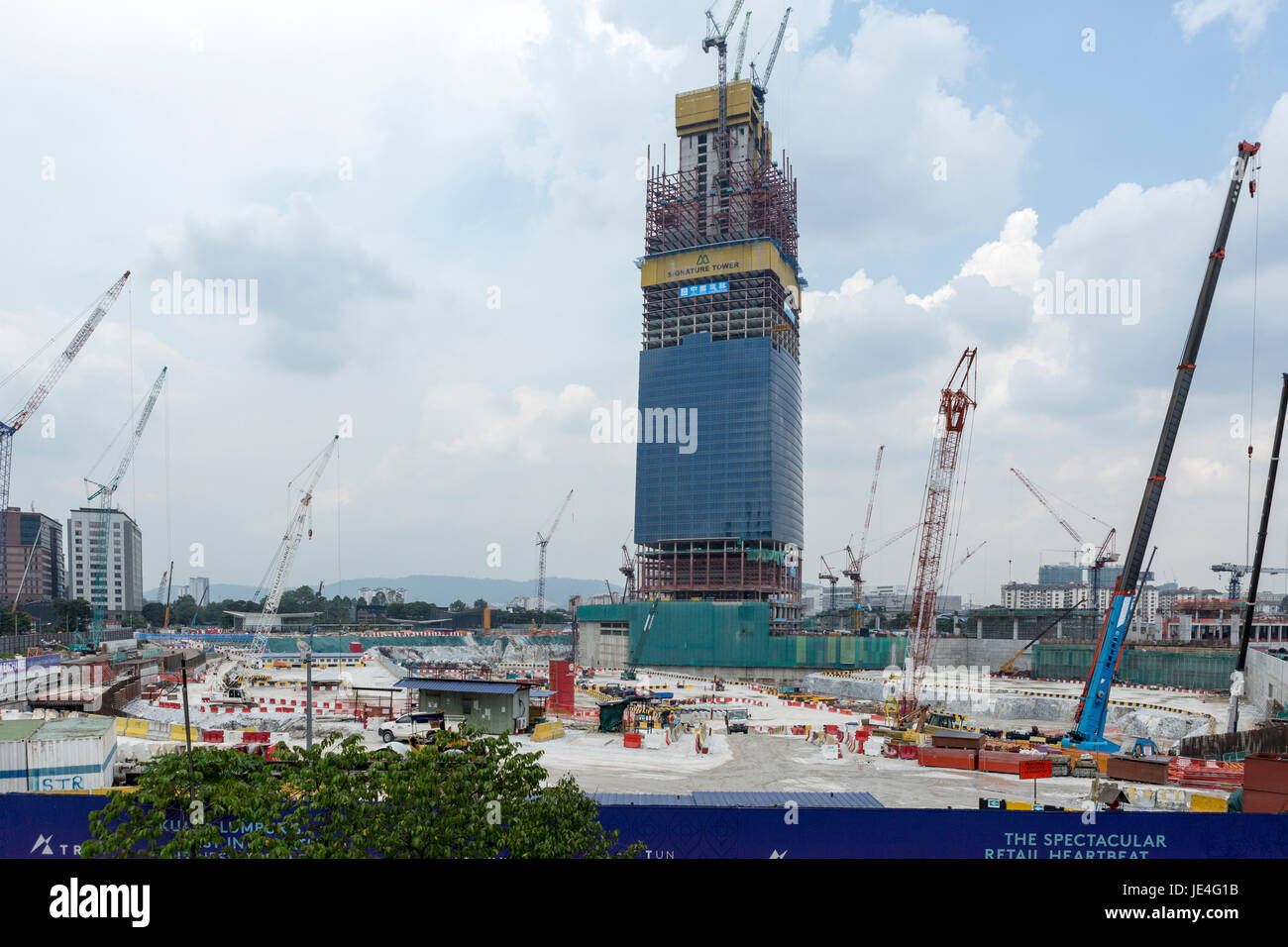 Cranes operate at the under construction Signature Tower in the Tun Razak Exchange financial district, developed by TRX City Sdn., in Kuala Lumpur, Malaysia Stock Photo