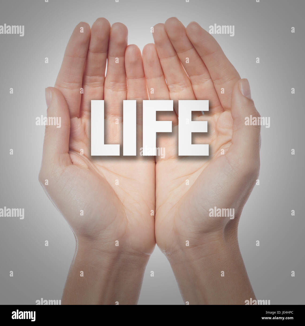 Two hands holding the word life Stock Photo - Alamy