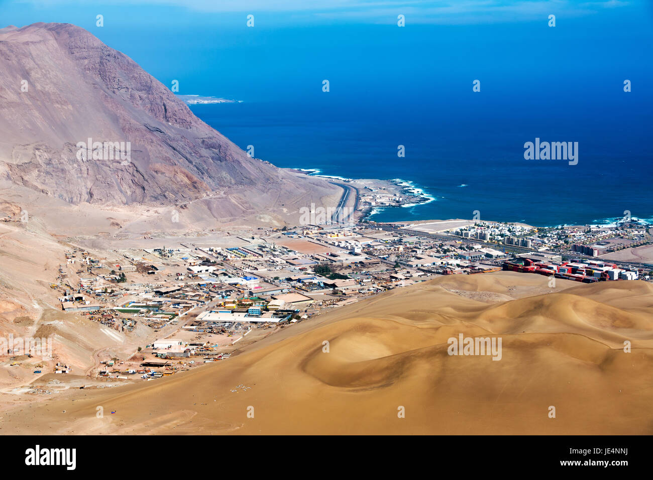 View of Iquique, Chile with sand dunes and Pacific Ocean visible Stock