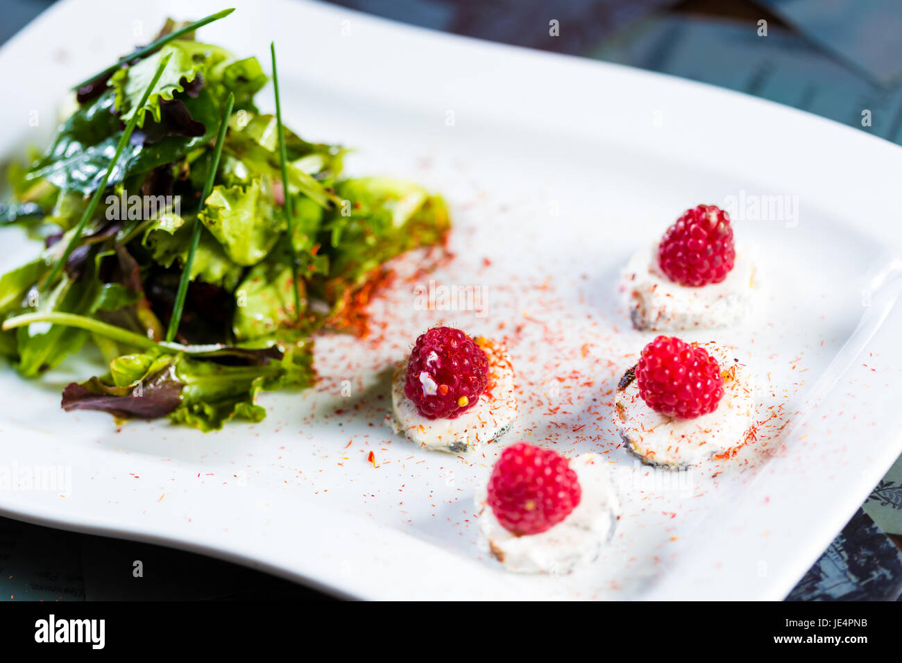 fresh salad with goat cheese and raspberry. Healthy Food Stock Photo
