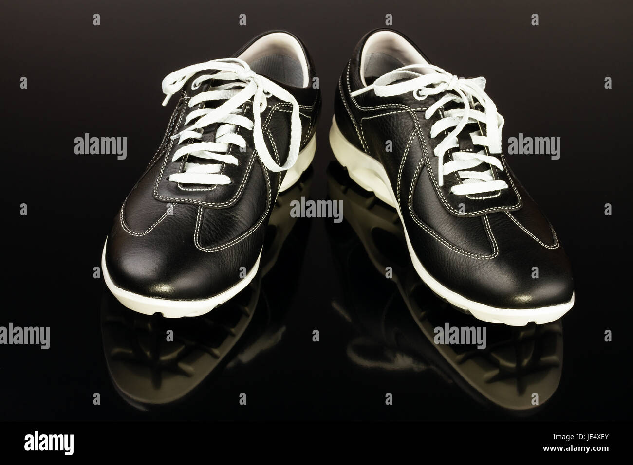 black leather man's shoe on black background Stock Photo - Alamy