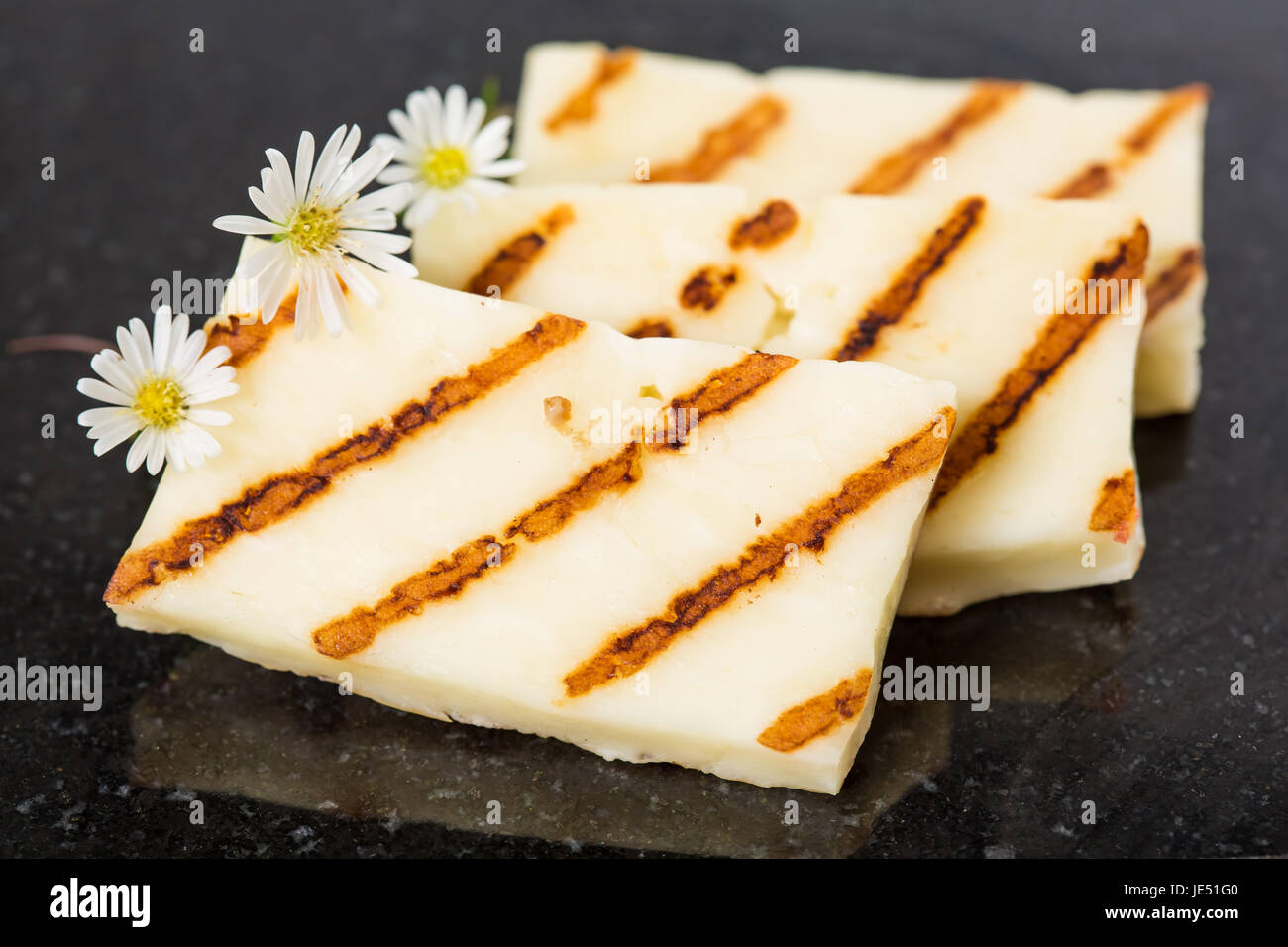 Halloumi cheese frying in grill pan. Closeup Stock Photo Alamy
