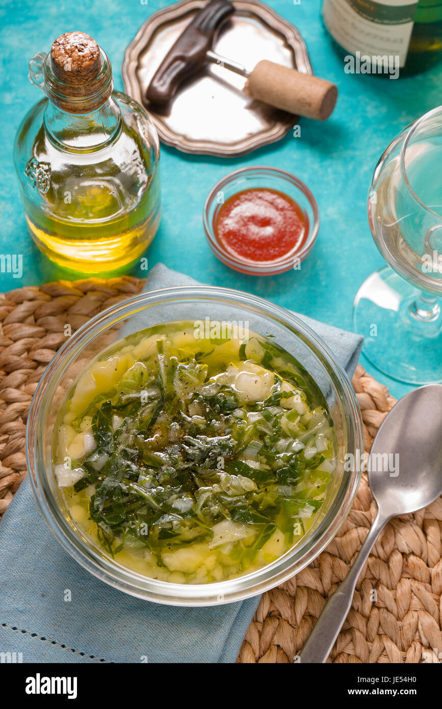 Portuguese soup Caldo Verde on the cyan background vertical Stock Photo