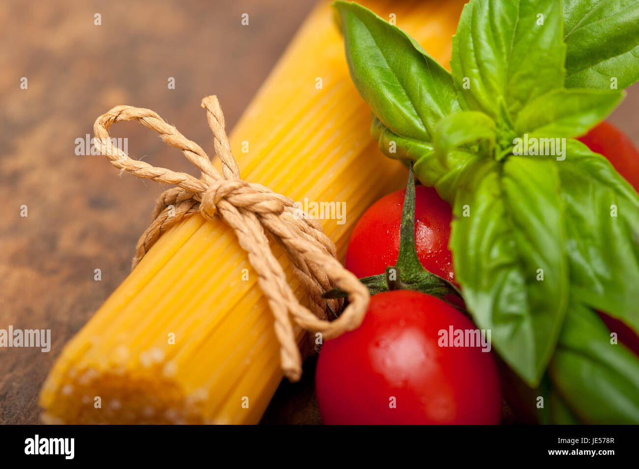 raw ingredients spaghetti pasta tomato and basil foundations of Italian