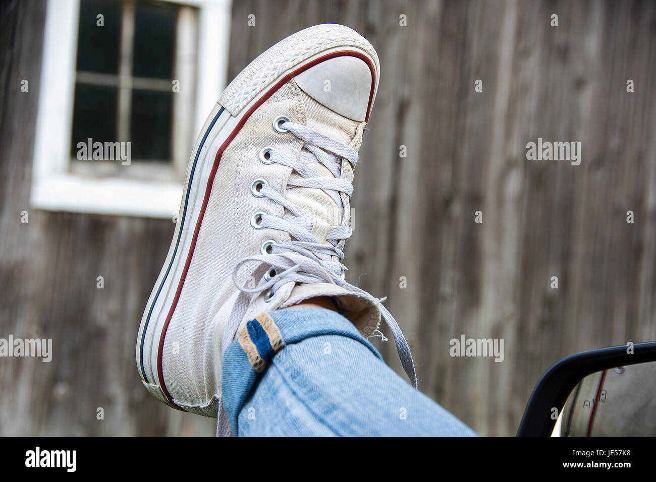 white sneaker hanging out of car window Stock Photo Alamy