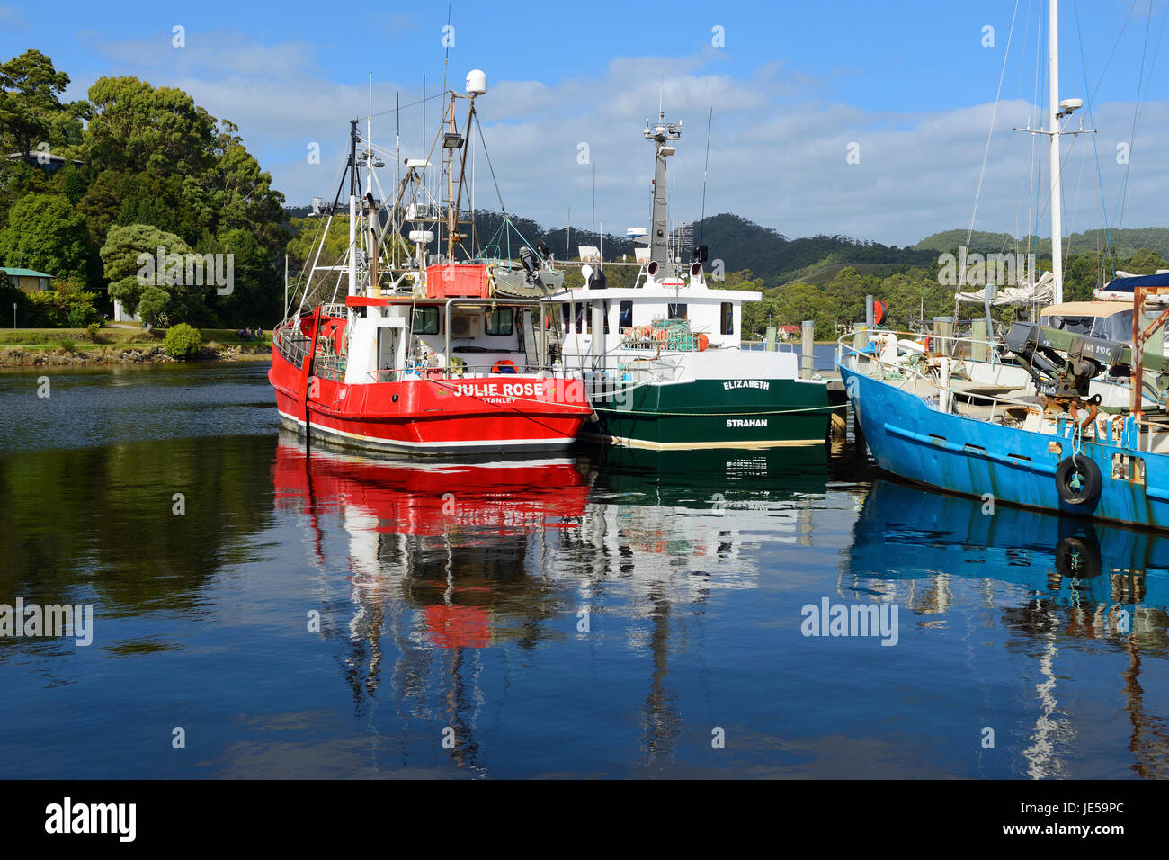 Fishing boats moored at Strahan wharf on west coast of Tasmania