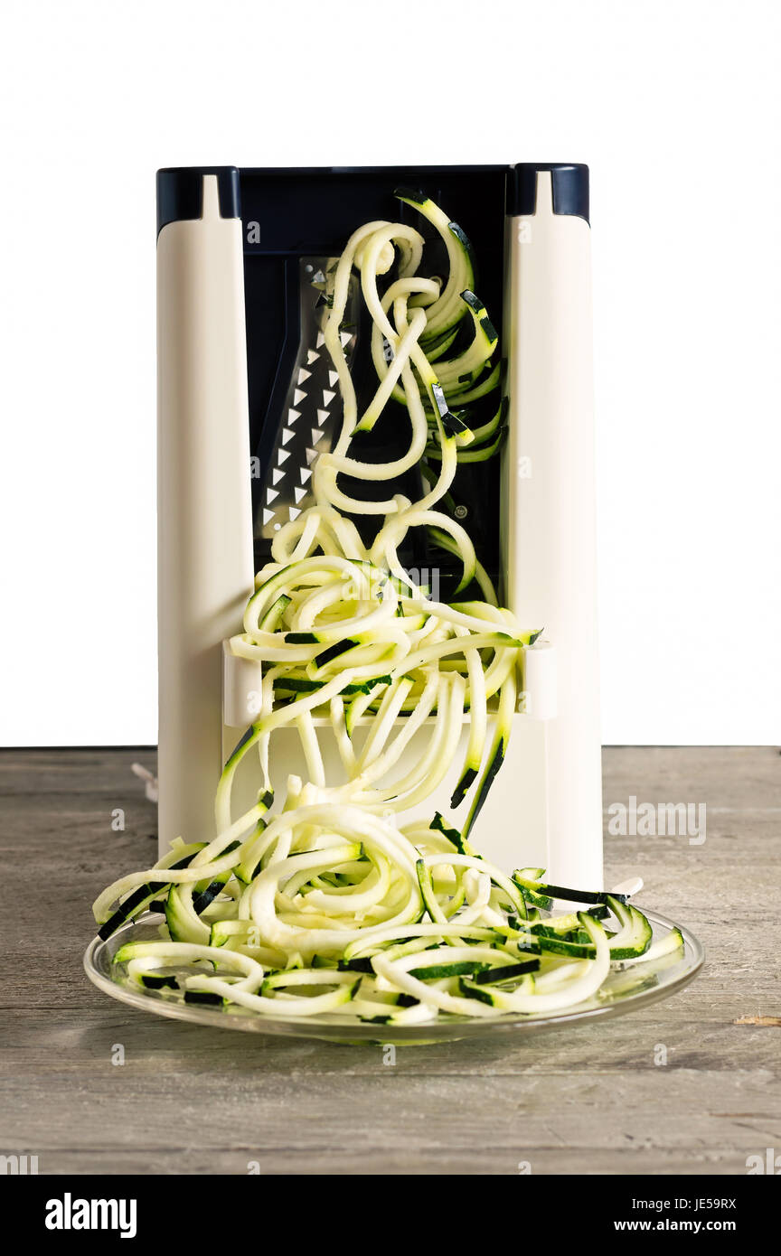 Front view of vegetable spiralizer making raw zucchini noodles