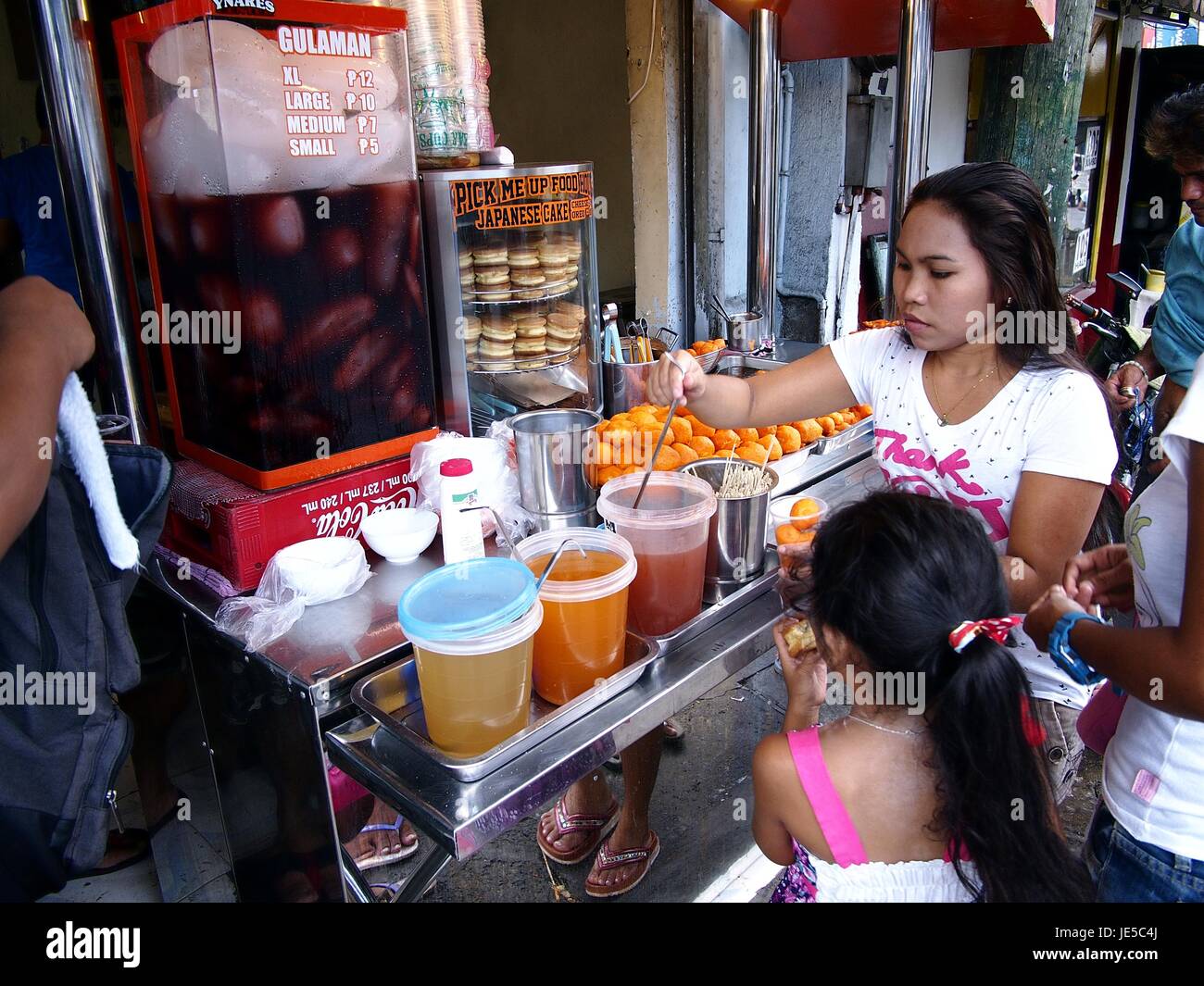 ANTIPOLO CITY, PHILIPPINES JUNE 14, 2017 A street food vendor sells