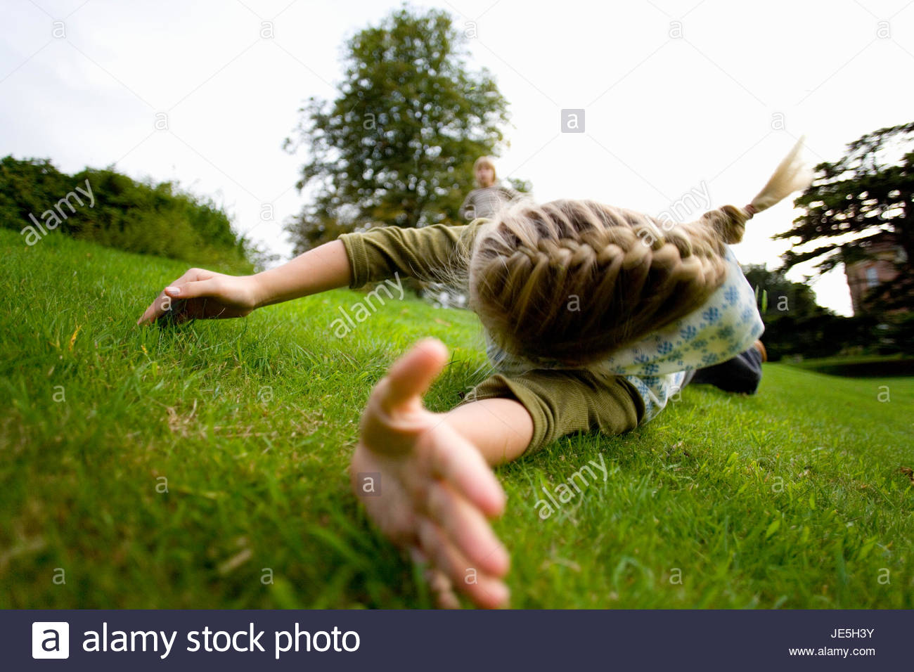 Girl Rolling Down Hill Stock Photos & Girl Rolling Down Hill Stock