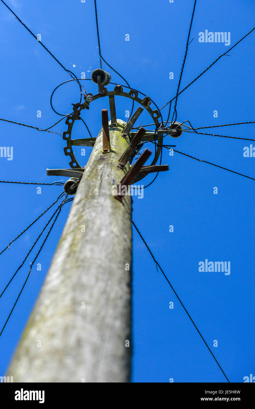 Telephone pole in residential location amid clear blue skies. Llandeilo, Carmarthenshire. Stock Photo