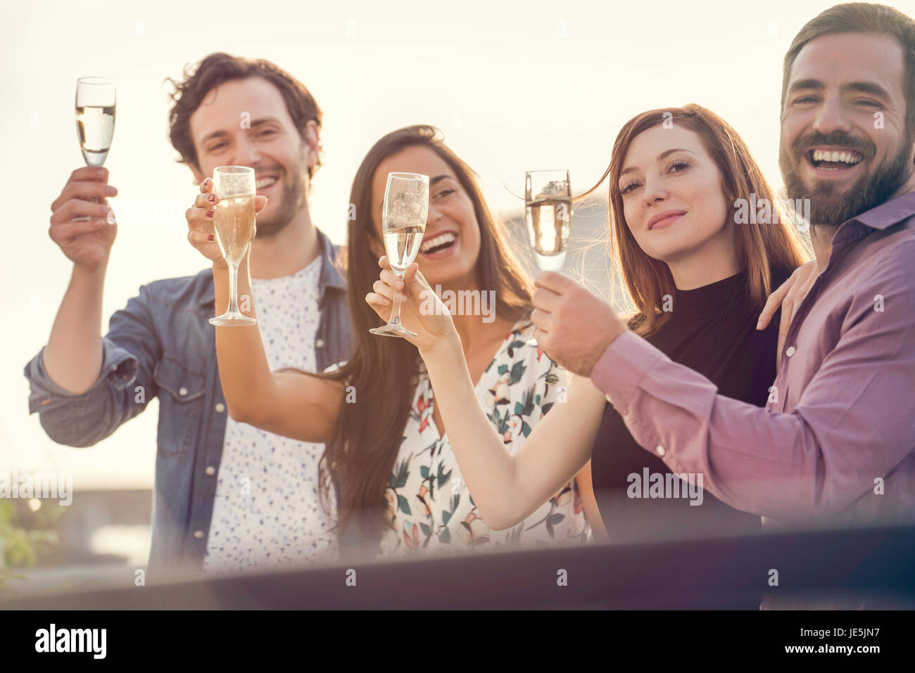 Friends drinking champagne together outdoors Stock Photo