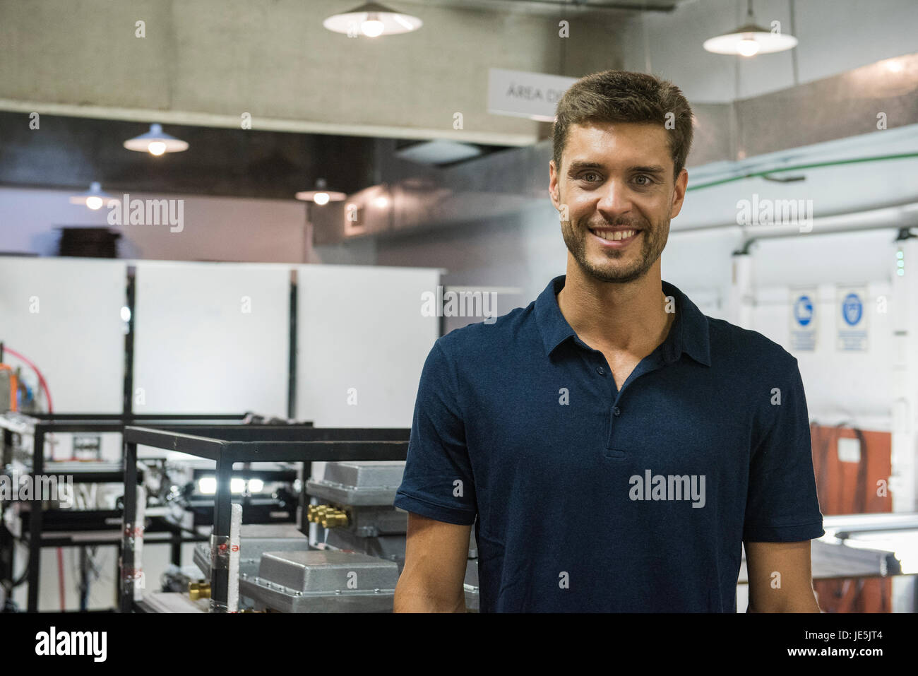 Man smiling in factory, portrait Stock Photo