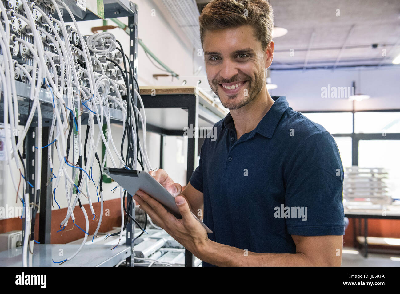 Electrical engineer smiling cheerfully, portrait Stock Photo