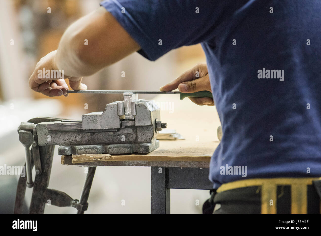 Man using file and vise in workshop, cropped Stock Photo - Alamy